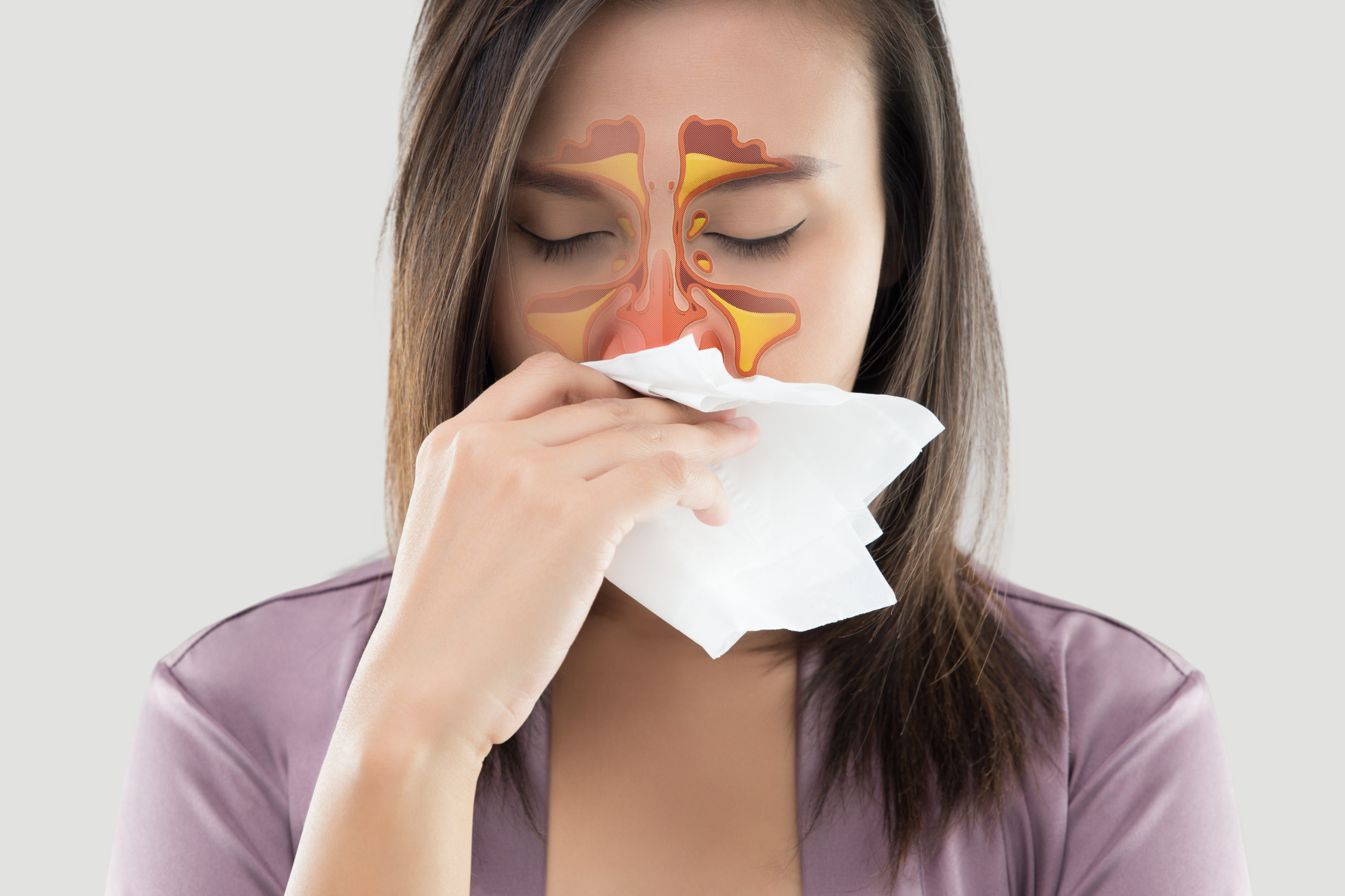 Women sneezing with a graphic on her cheeks and forehead indicating pain