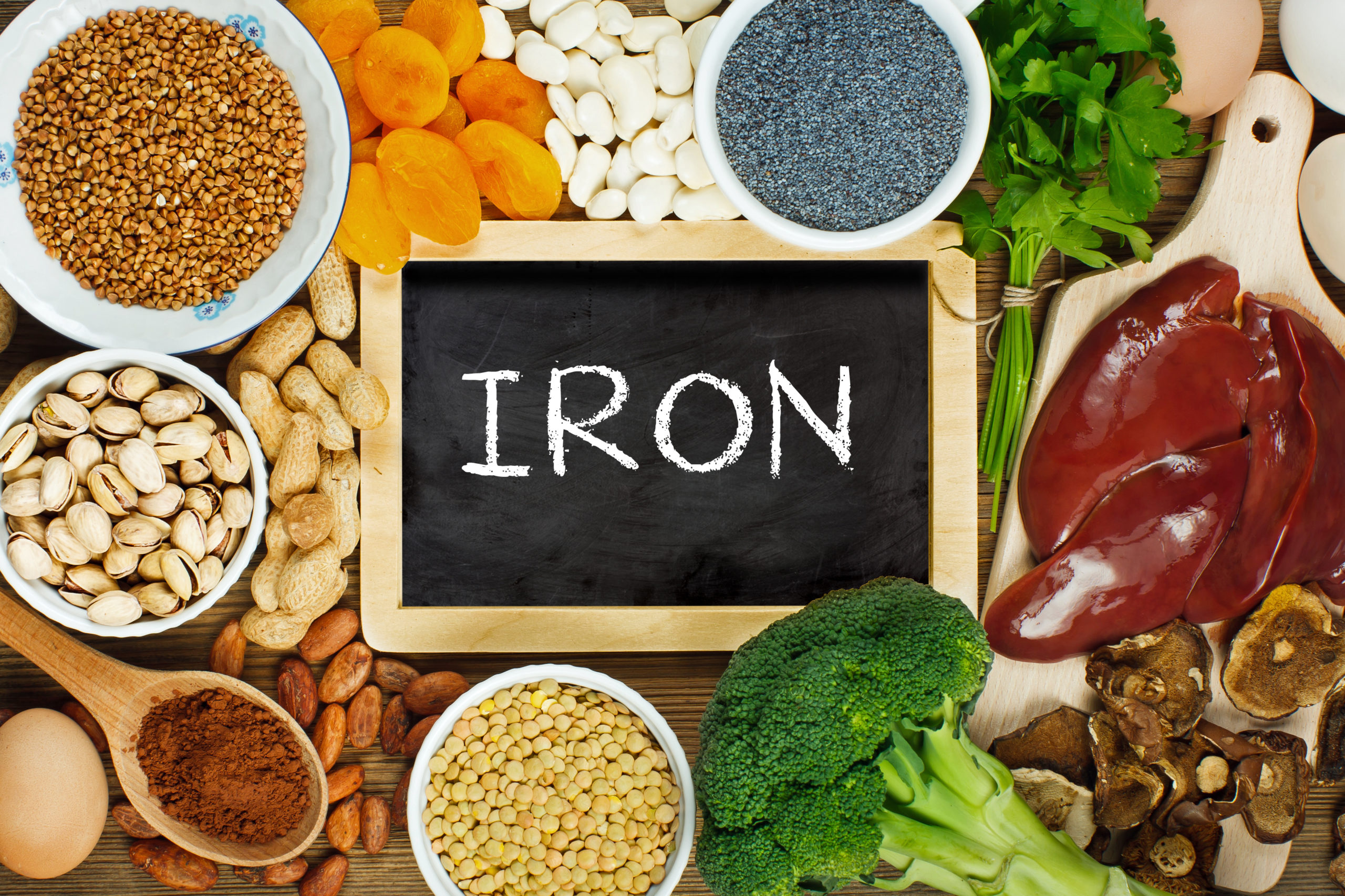 A selection of foods on the table with a sign that reads iron